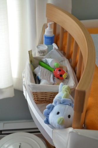 the left bin holds diaper cream, a brush and comb, lotion, and a toy — a must once your baby starts rolling over and needs distraction
