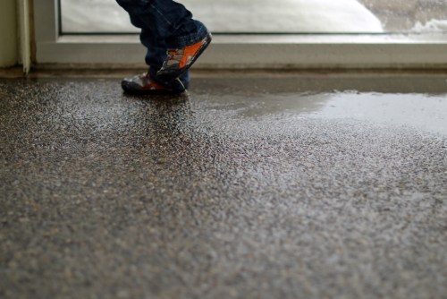 Little feet jumping up and down in a puddle. 